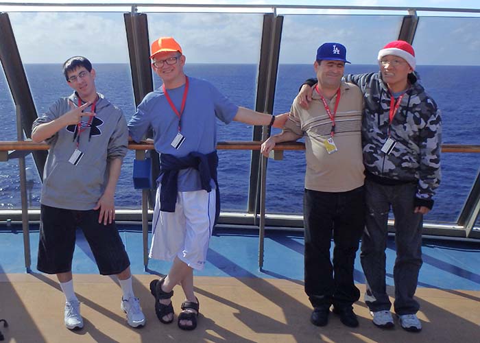 four guys on the deck of cruise ship hanging out